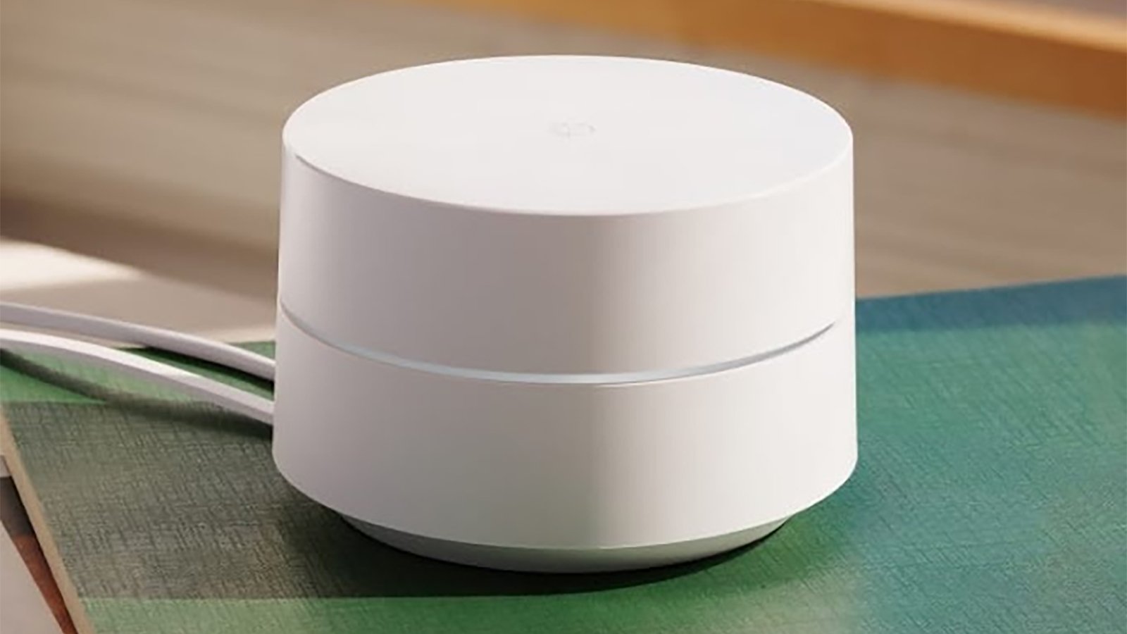 A Google Wifi device on a coffee table