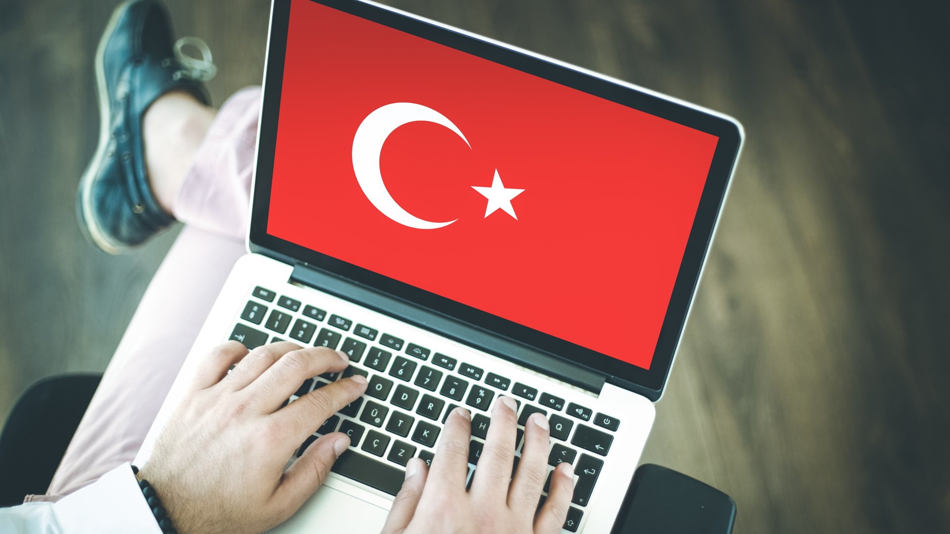 Persona que usa una computadora portátil con la bandera de Turquía en la pantalla