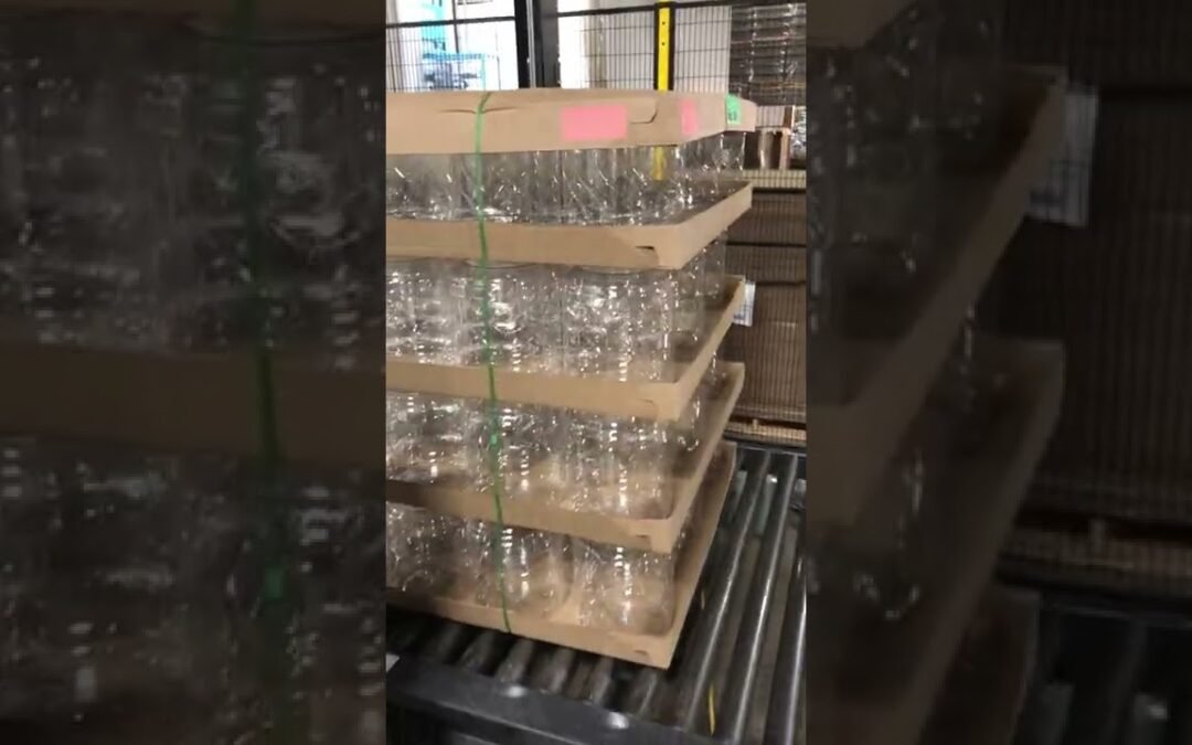 Wulftec Automatic Strapper and Wrapper System doing plastic bottles