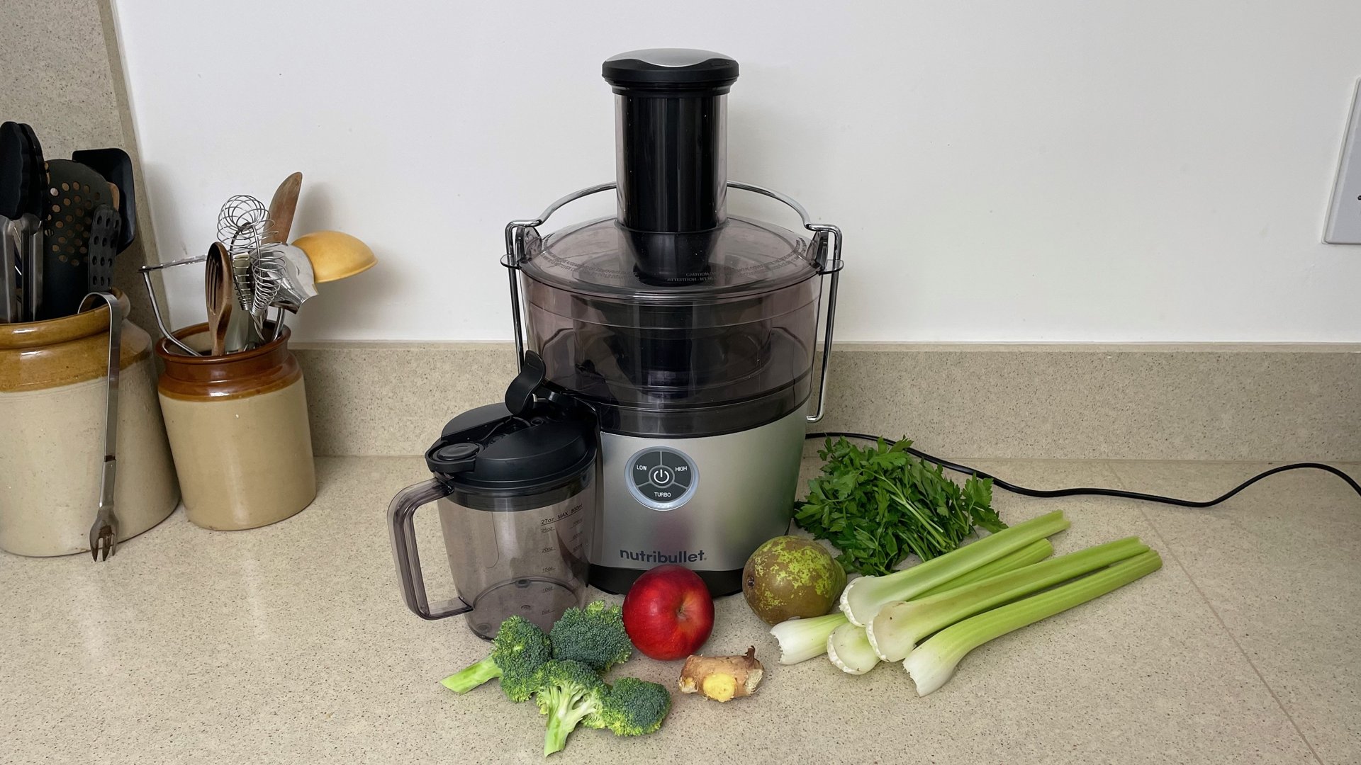 green juice ingredients next to juice extractor